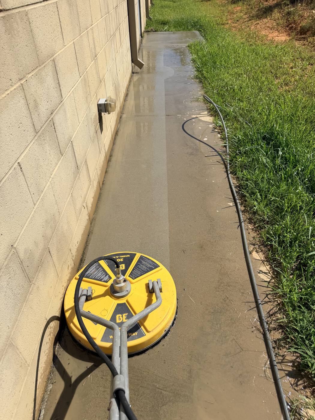 Clean walkway next to a home foundation