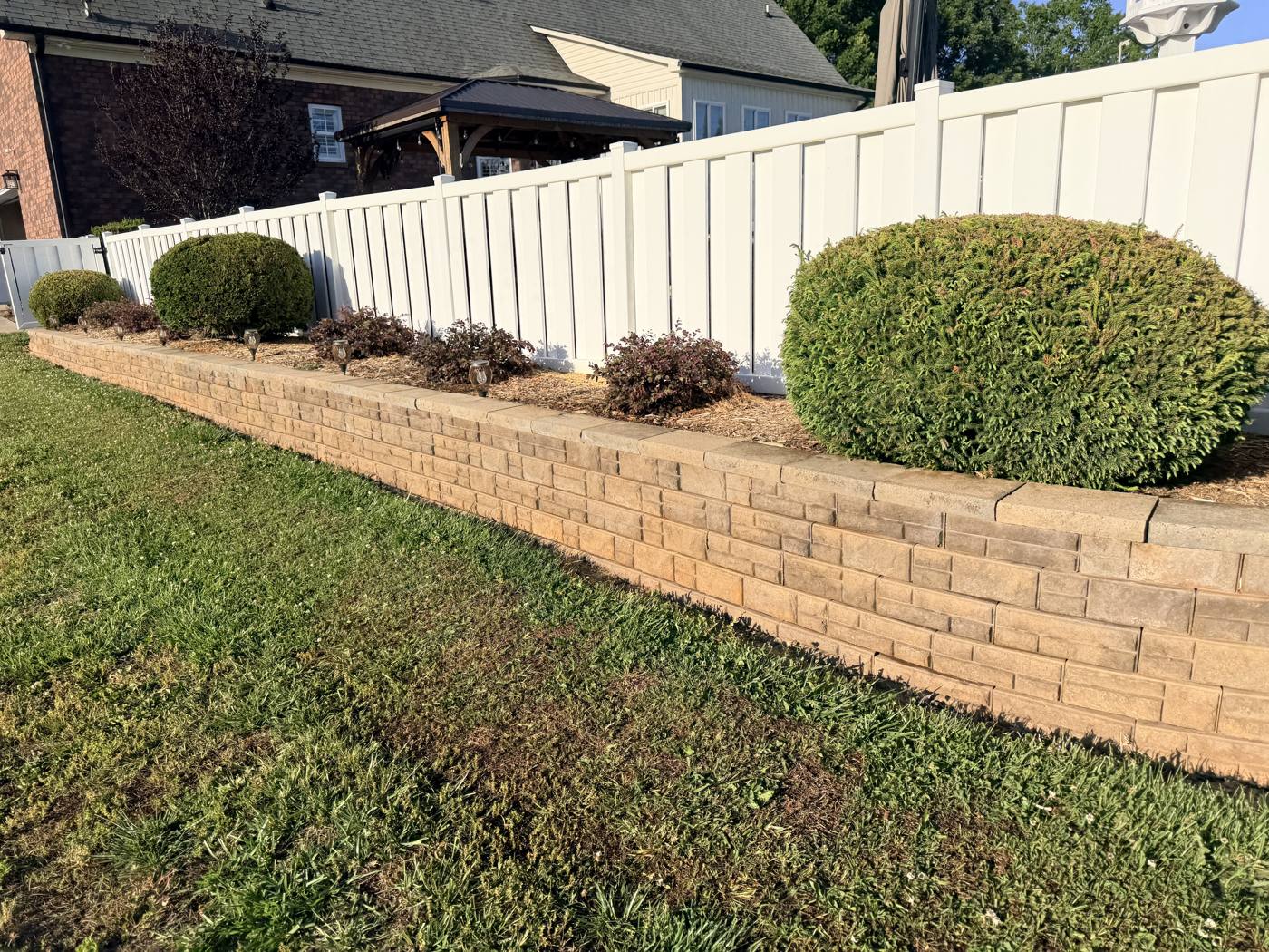 Same retaining wall, cleaned back to its natural tan stone color